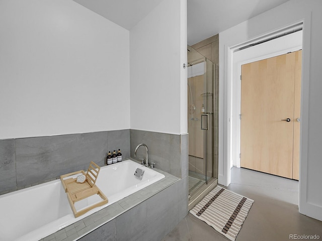 full bathroom featuring a shower stall and a bath
