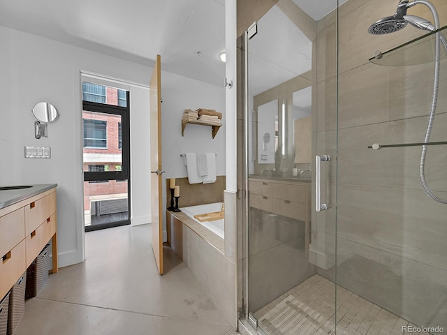 full bath with a shower stall, vanity, and a bath