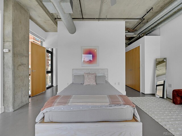 bedroom with a ceiling fan and finished concrete floors