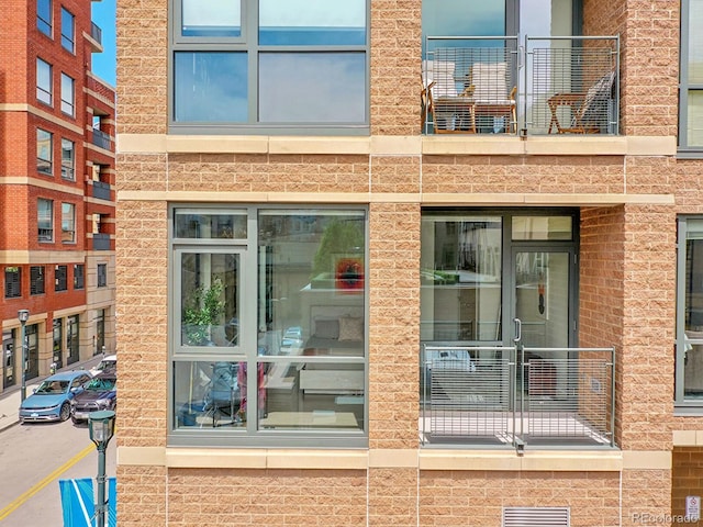 doorway to property with brick siding