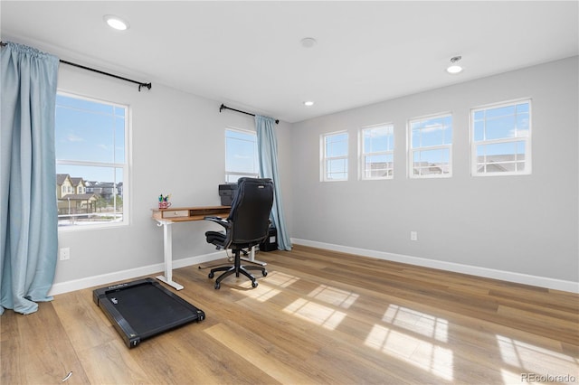 office space with recessed lighting, baseboards, and light wood finished floors