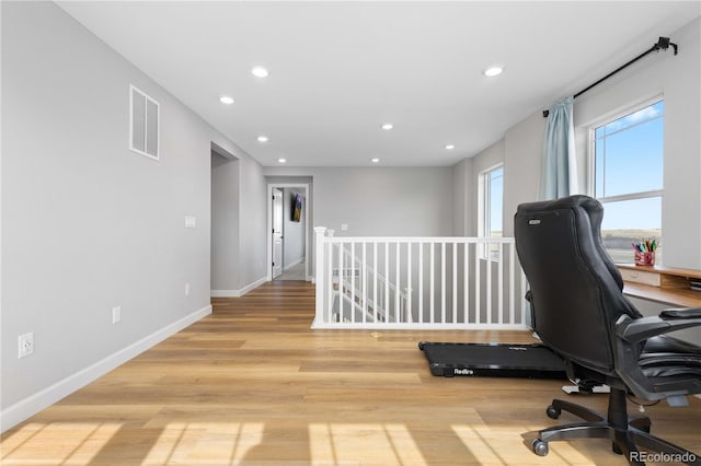 office space with baseboards, recessed lighting, light wood-style flooring, and visible vents