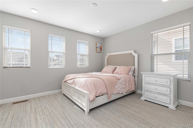 bedroom featuring baseboards, recessed lighting, visible vents, and light carpet