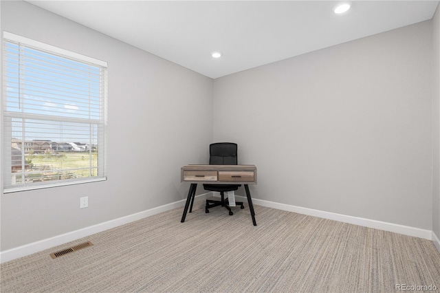 office with baseboards, visible vents, and a wealth of natural light