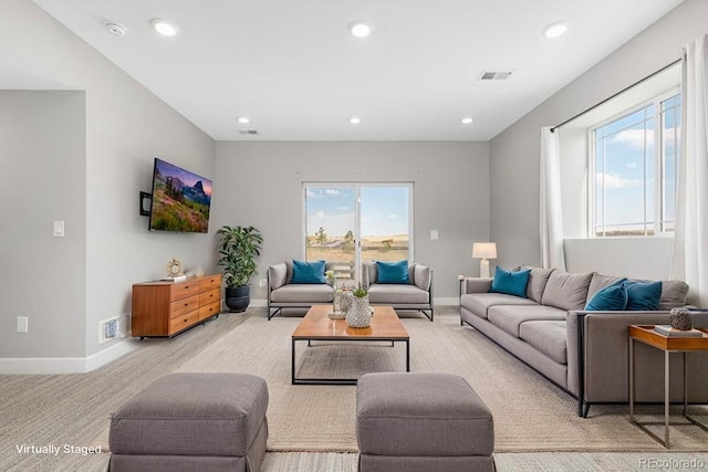 living room featuring baseboards, recessed lighting, and visible vents