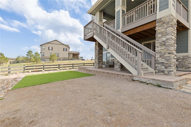 view of yard featuring stairway, a deck, fence, and a patio area