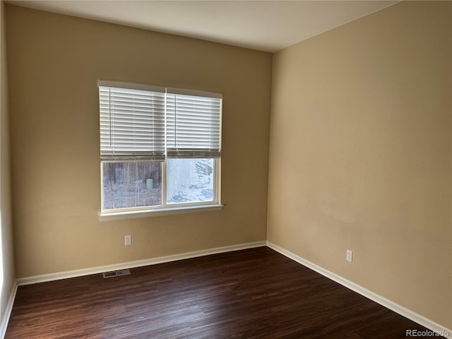 spare room with dark hardwood / wood-style floors