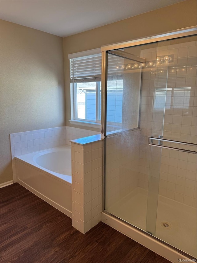 bathroom featuring hardwood / wood-style floors and shower with separate bathtub