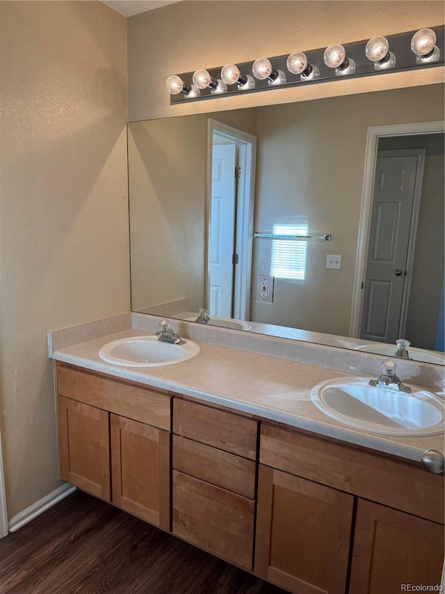 bathroom with hardwood / wood-style flooring and vanity