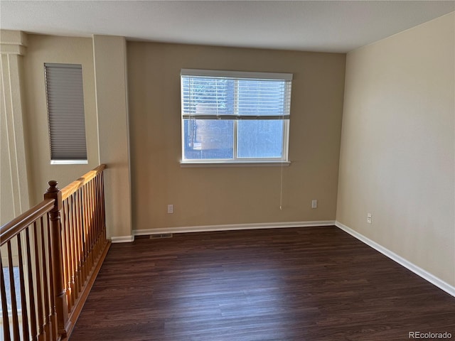 empty room with dark hardwood / wood-style floors