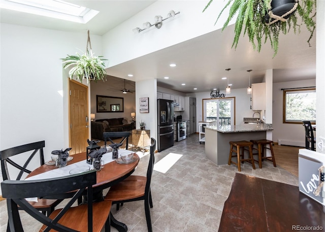 630 Rock Creek Mesa Rd, Colorado Springs, CO 80926 - dining area with recessed lighting, a skylight, a baseboard heating unit, and ceiling fan
