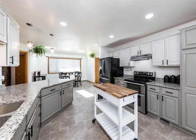 630 Rock Creek Mesa Rd, Colorado Springs, CO 80926 - kitchen with gray cabinetry, under cabinet range hood, range with two ovens, recessed lighting, and black fridge