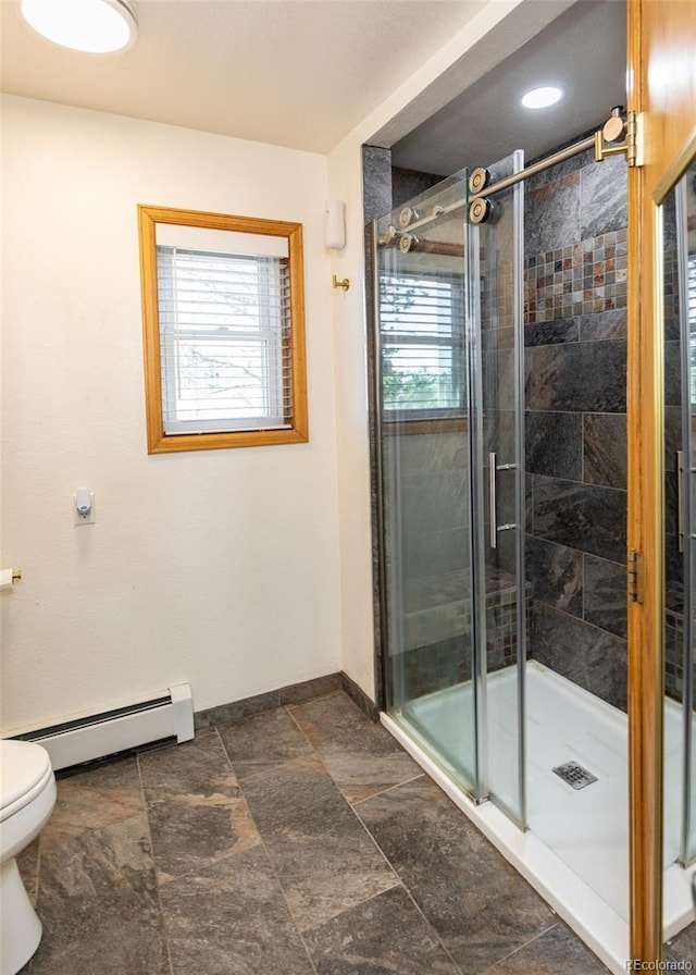 630 Rock Creek Mesa Rd, Colorado Springs, CO 80926 - bathroom featuring a baseboard heating unit, toilet, a stall shower, and plenty of natural light