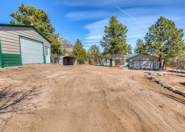 630 Rock Creek Mesa Rd, Colorado Springs, CO 80926 - view of yard with an outdoor structure, a garage, and driveway