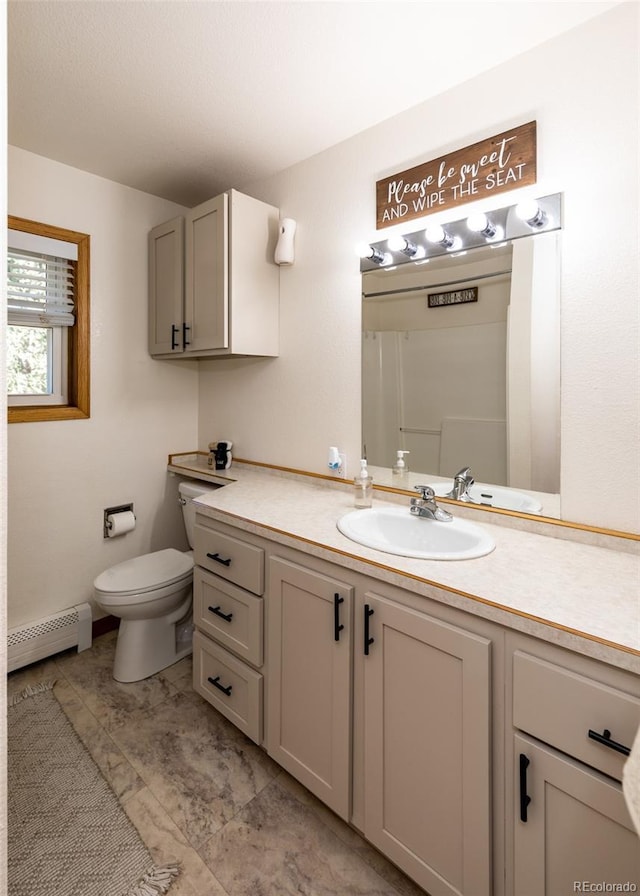 630 Rock Creek Mesa Rd, Colorado Springs, CO 80926 - bathroom with a baseboard heating unit, toilet, and vanity