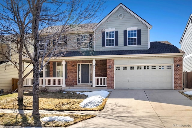 traditional-style house with covered porch, a garage, brick siding, a shingled roof, and driveway