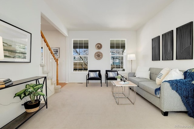 living room with carpet and stairs