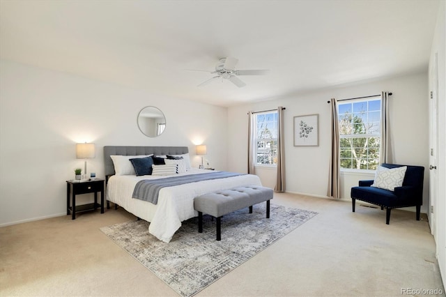 bedroom featuring light colored carpet, ceiling fan, baseboards, and multiple windows