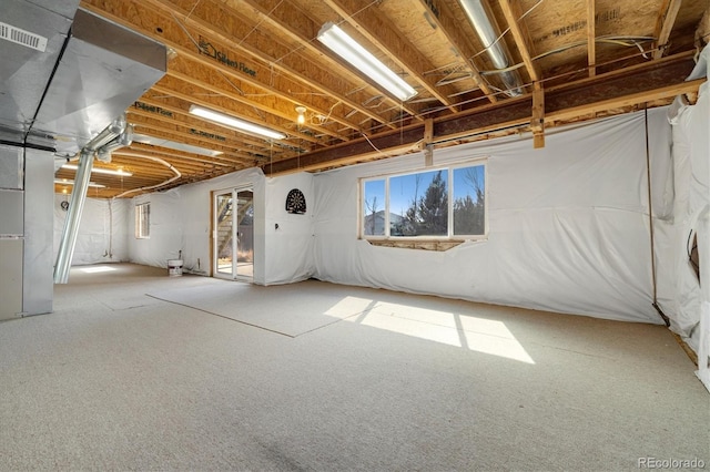 basement featuring heating unit and visible vents