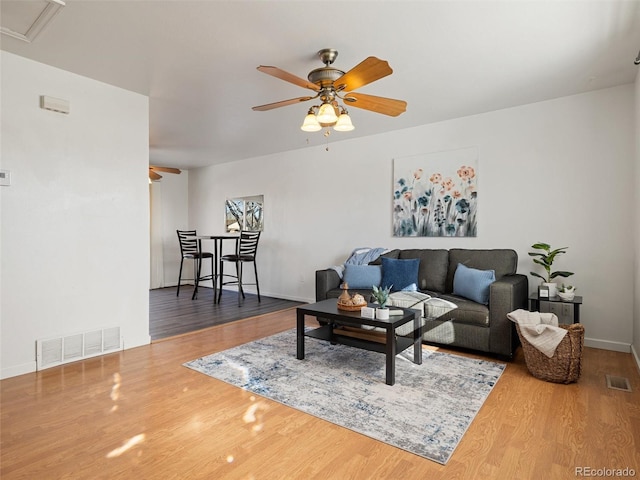 living room with ceiling fan and hardwood / wood-style flooring