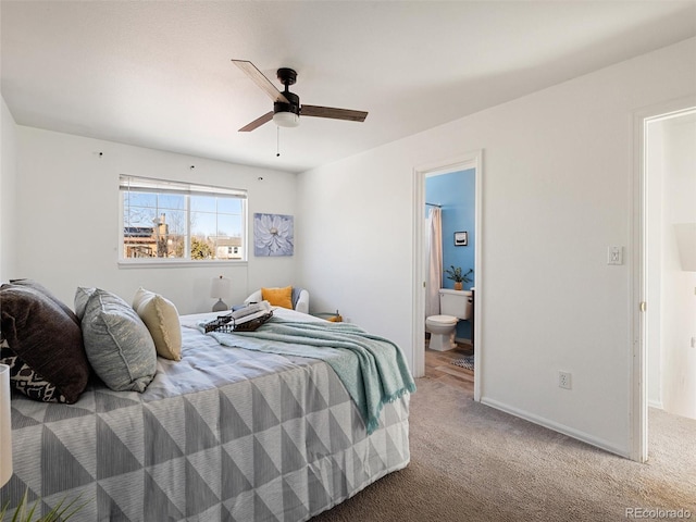 carpeted bedroom with ceiling fan and ensuite bath