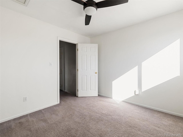 carpeted spare room with ceiling fan