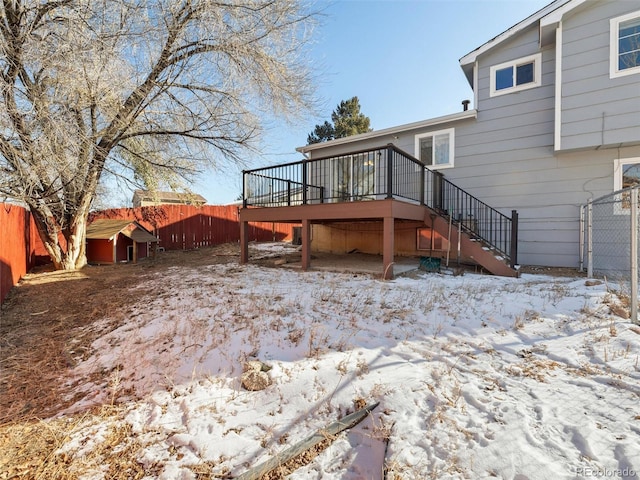 snow covered house featuring a deck