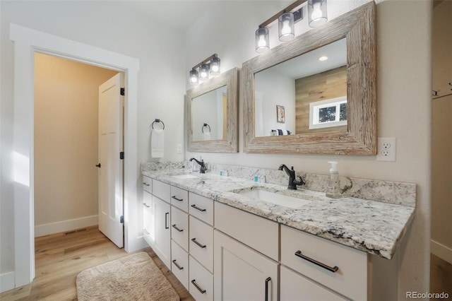 bathroom with vanity and hardwood / wood-style floors