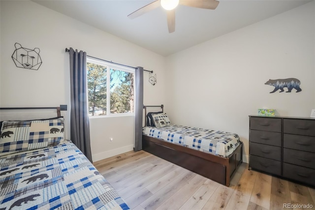 bedroom with ceiling fan and light wood-type flooring