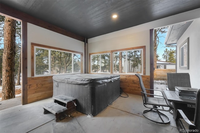 interior space with concrete flooring and a jacuzzi