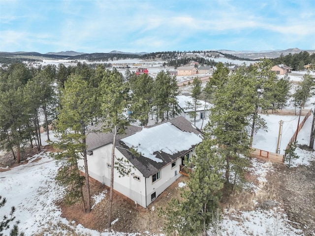 snowy aerial view with a mountain view