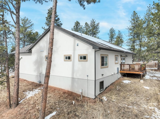 view of home's exterior featuring a wooden deck