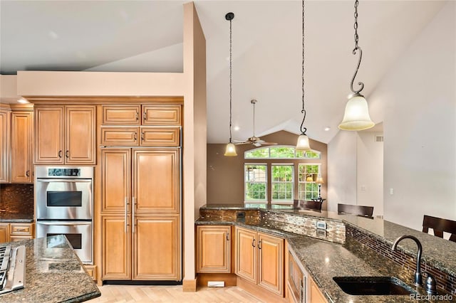 3231 Oak St, Wheat Ridge, CO 80033 - kitchen featuring double oven, lofted ceiling, dark stone countertops, tasteful backsplash, and a ceiling fan