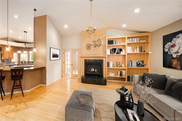 3231 Oak St, Wheat Ridge, CO 80033 - living area with vaulted ceiling, light wood-style floors, a premium fireplace, and recessed lighting