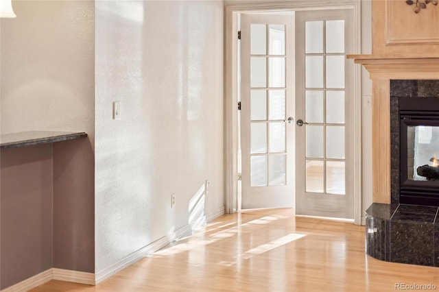 3231 Oak St, Wheat Ridge, CO 80033 - doorway with light wood-style flooring, french doors, and a premium fireplace