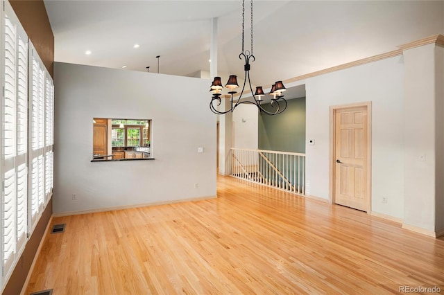3231 Oak St, Wheat Ridge, CO 80033 - unfurnished room with wood finished floors, a chandelier, recessed lighting, and high vaulted ceiling