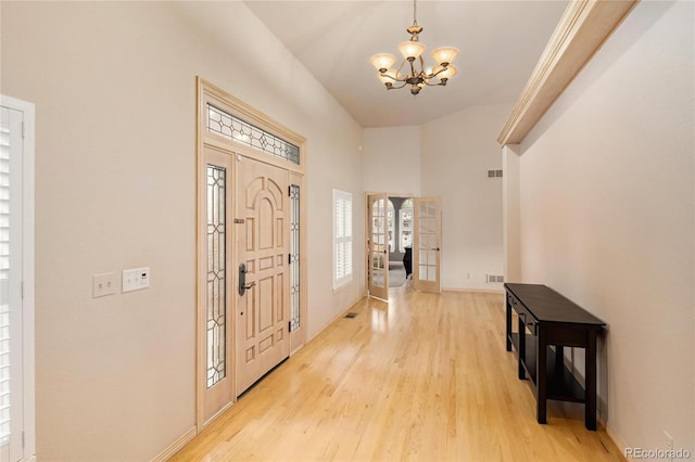 3231 Oak St, Wheat Ridge, CO 80033 - entrance foyer with a chandelier, light wood-style floors, and french doors