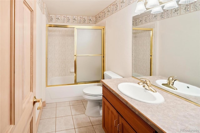 3231 Oak St, Wheat Ridge, CO 80033 - bathroom featuring vanity, bath / shower combo with glass door, and tile patterned flooring