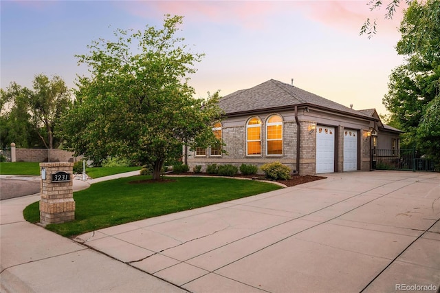 3231 Oak St, Wheat Ridge, CO 80033 - french provincial home featuring brick siding, a garage, concrete driveway, and a shingled roof