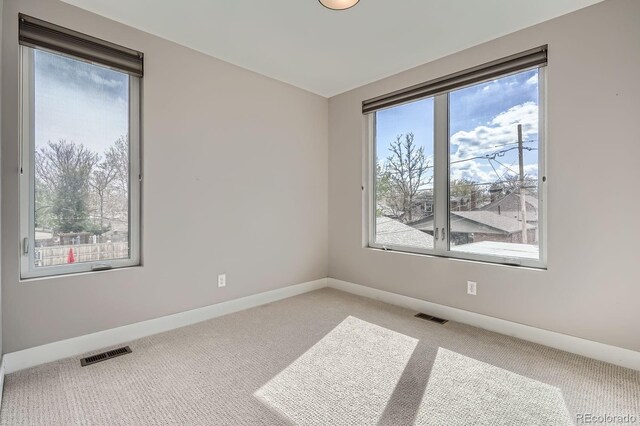 empty room with light colored carpet and baseboards