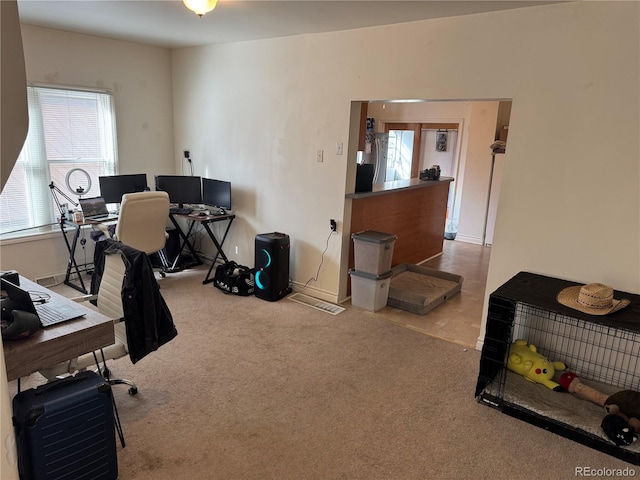 carpeted home office with french doors and baseboards