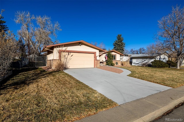 ranch-style house featuring a front yard and a garage