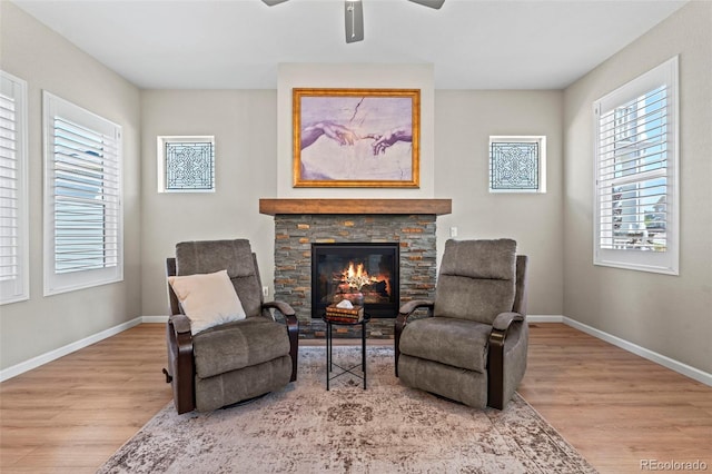 48 Mayflower Park Pl, Colorado Springs, CO 80905 - living area featuring wood finished floors, ceiling fan, and a stone fireplace