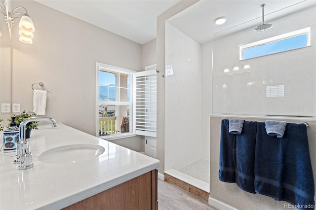 48 Mayflower Park Pl, Colorado Springs, CO 80905 - full bathroom featuring wood finished floors, double vanity, and a walk in shower