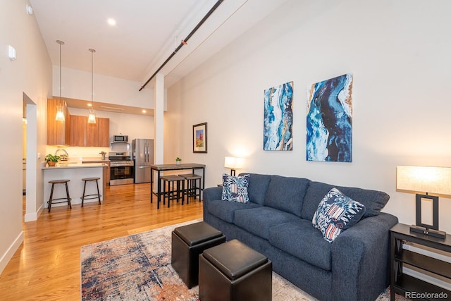 824 Grand Ave Unit 4, Grand Lake, CO 80447 - living area featuring light wood-style flooring and a towering ceiling