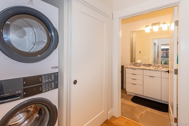 824 Grand Ave Unit 4, Grand Lake, CO 80447 - laundry room featuring stacked washer and clothes dryer and light tile patterned floors