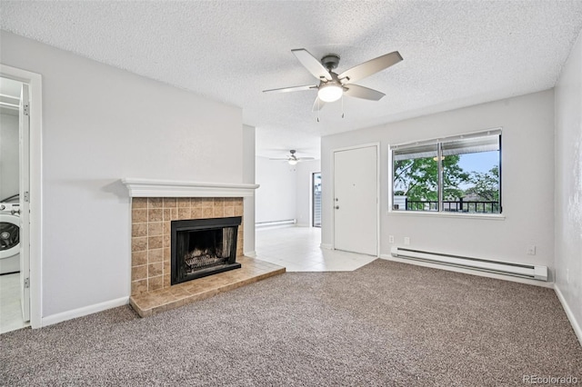7825 Barbara Ann Dr Unit I, Arvada, CO 80004 - unfurnished living room featuring baseboard heating, ceiling fan, washer / clothes dryer, a tiled fireplace, and carpet flooring