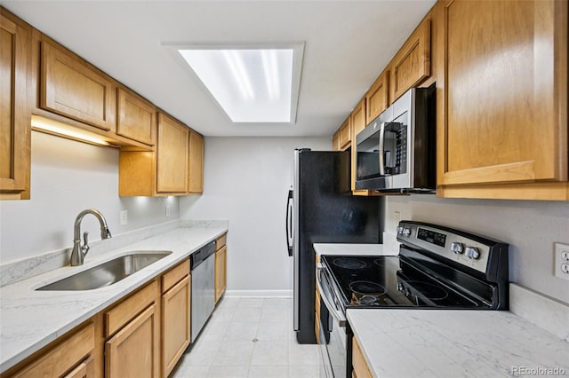 7825 Barbara Ann Dr Unit I, Arvada, CO 80004 - kitchen featuring stainless steel appliances, light stone counters, and brown cabinetry