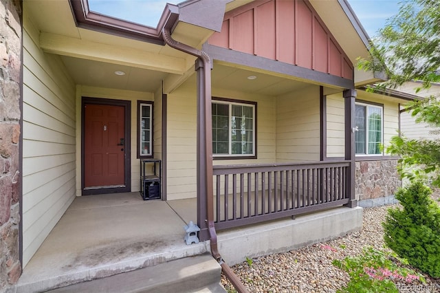 5770 Waverley Ave, Firestone, CO 80504 - view of exterior entry with board and batten siding, a porch, and stone siding