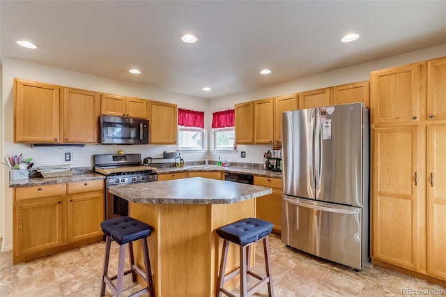 5770 Waverley Ave, Firestone, CO 80504 - kitchen with stainless steel appliances, a kitchen bar, a sink, recessed lighting, and a center island